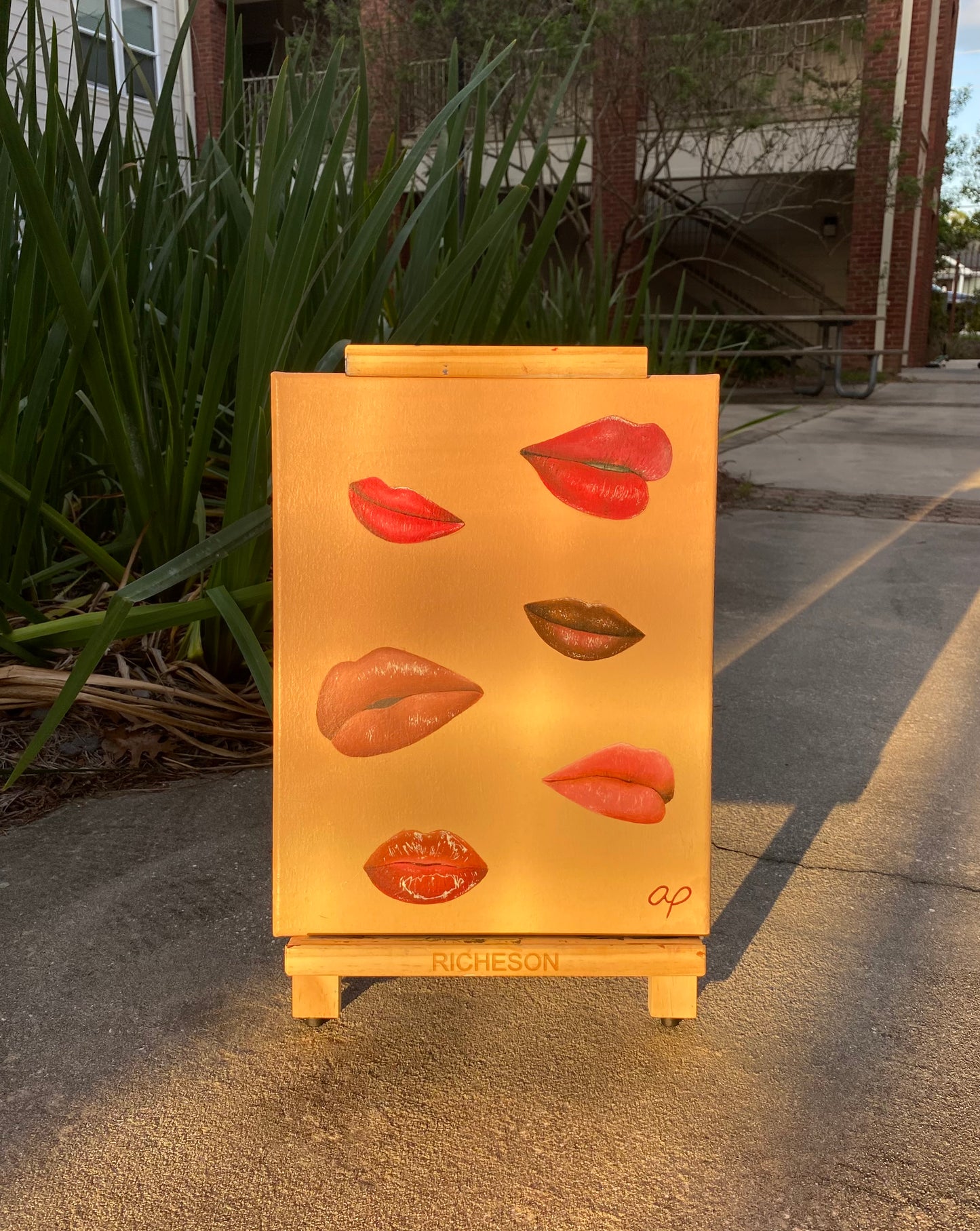 Amber Peeks Art: Canvas painting of lips outside with the sun shining.