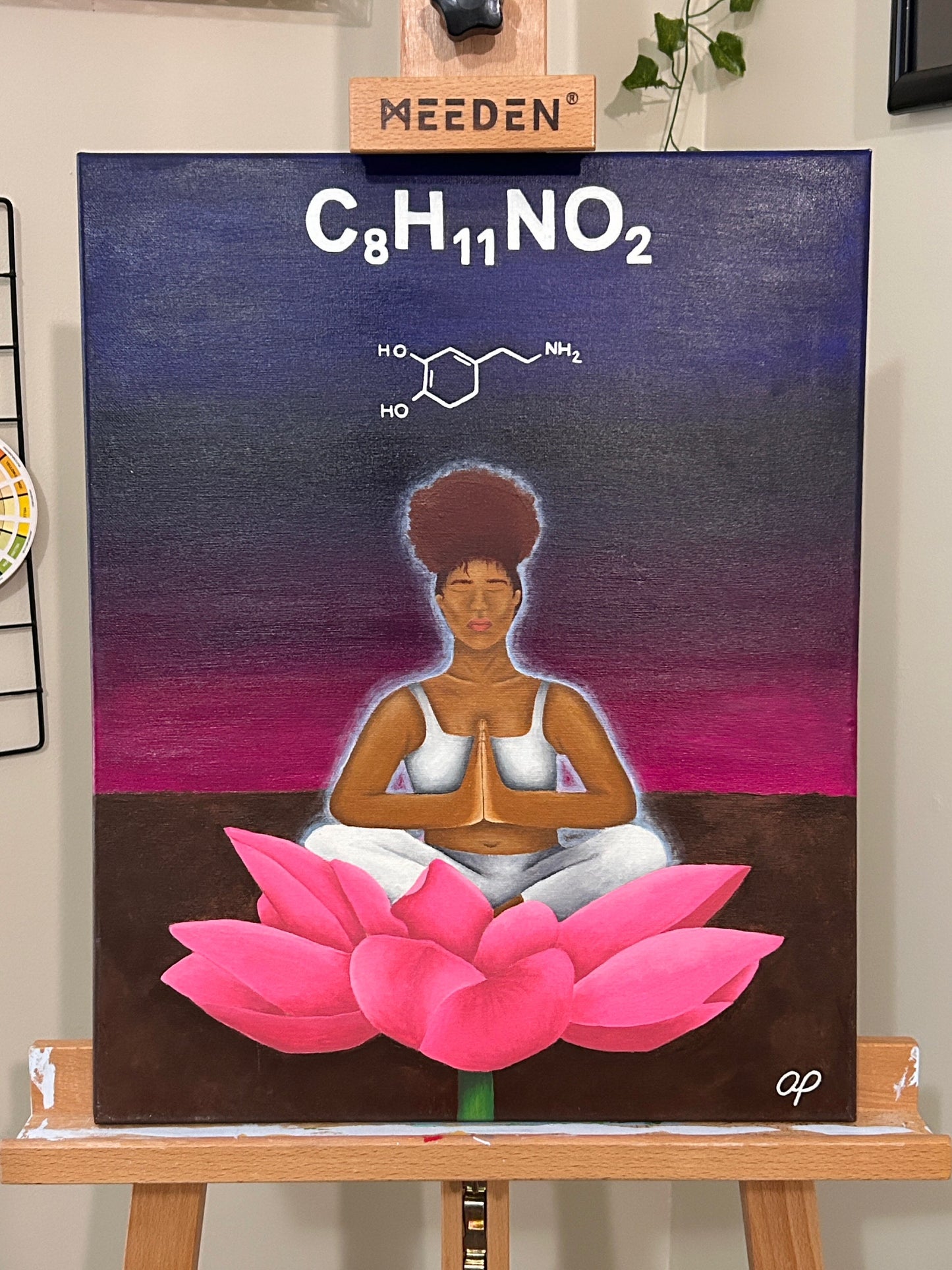 Amber Peeks Art: Painting of a person meditating on a pink lotus with chemical formula on a dark background, displayed on an easel.