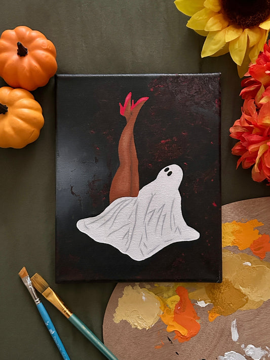 Amber Peeks Art: Canvas with ghost painting surrounded by pumpkins and sunflowers on a dark surface