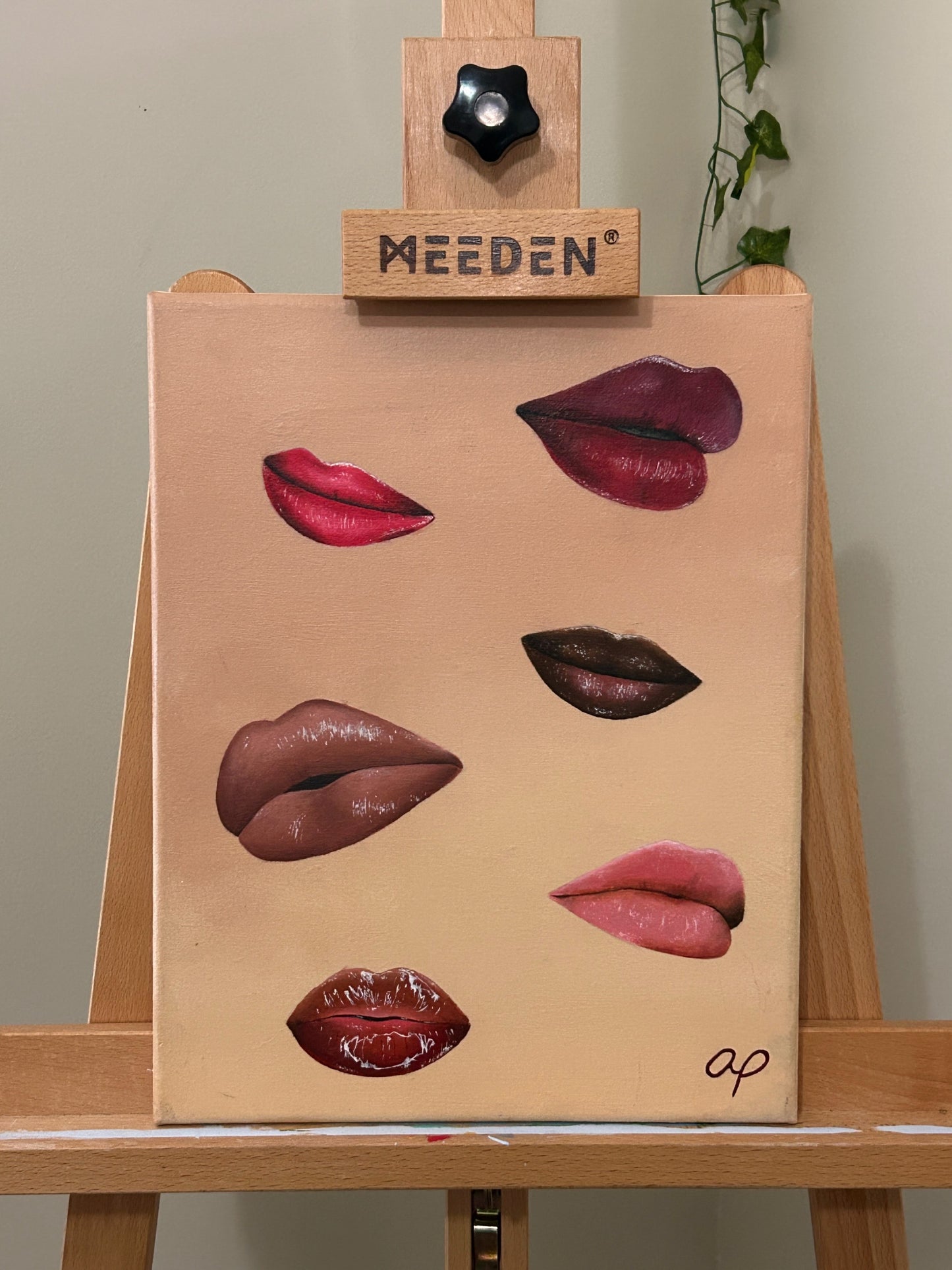 Amber Peeks Art: Canvas painting with lips on a wooden easel.