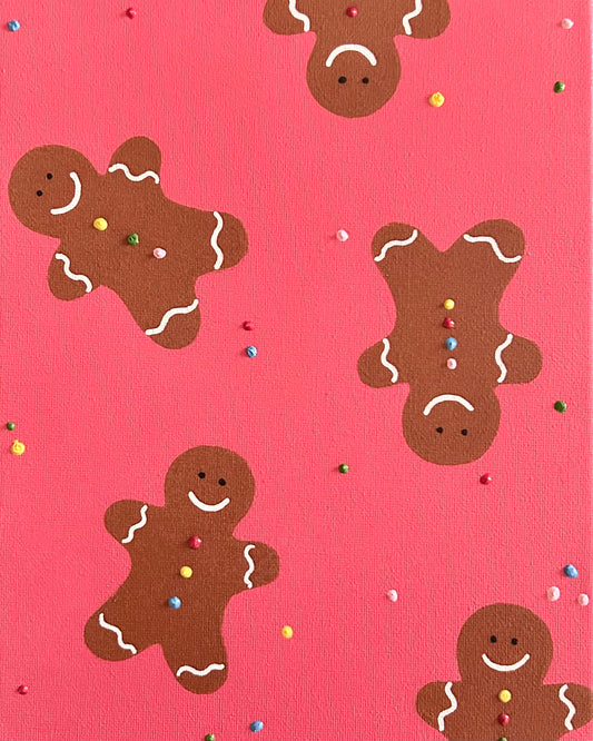 Pattern of gingerbread men on a pink background with sprinkles.