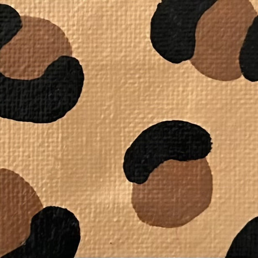 Amber Peeks Art: close-up image of leopard print painted on a miniature canvas magnet created by Atlanta multi-disciplinary visual artist Amber Peeks.