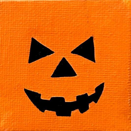 Black jack-o'-lantern face on an orange background
